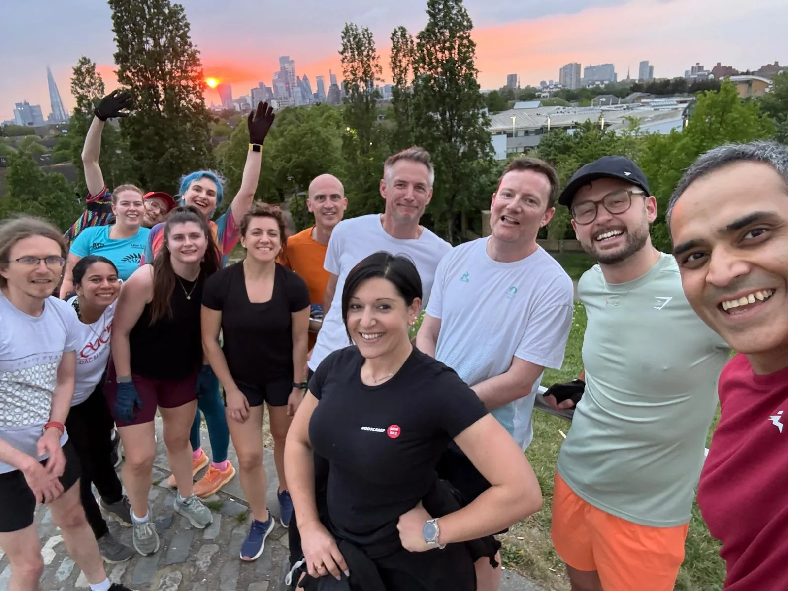 A Bootcamp SE16 group together at an evening session as the sun sets over the London skyline