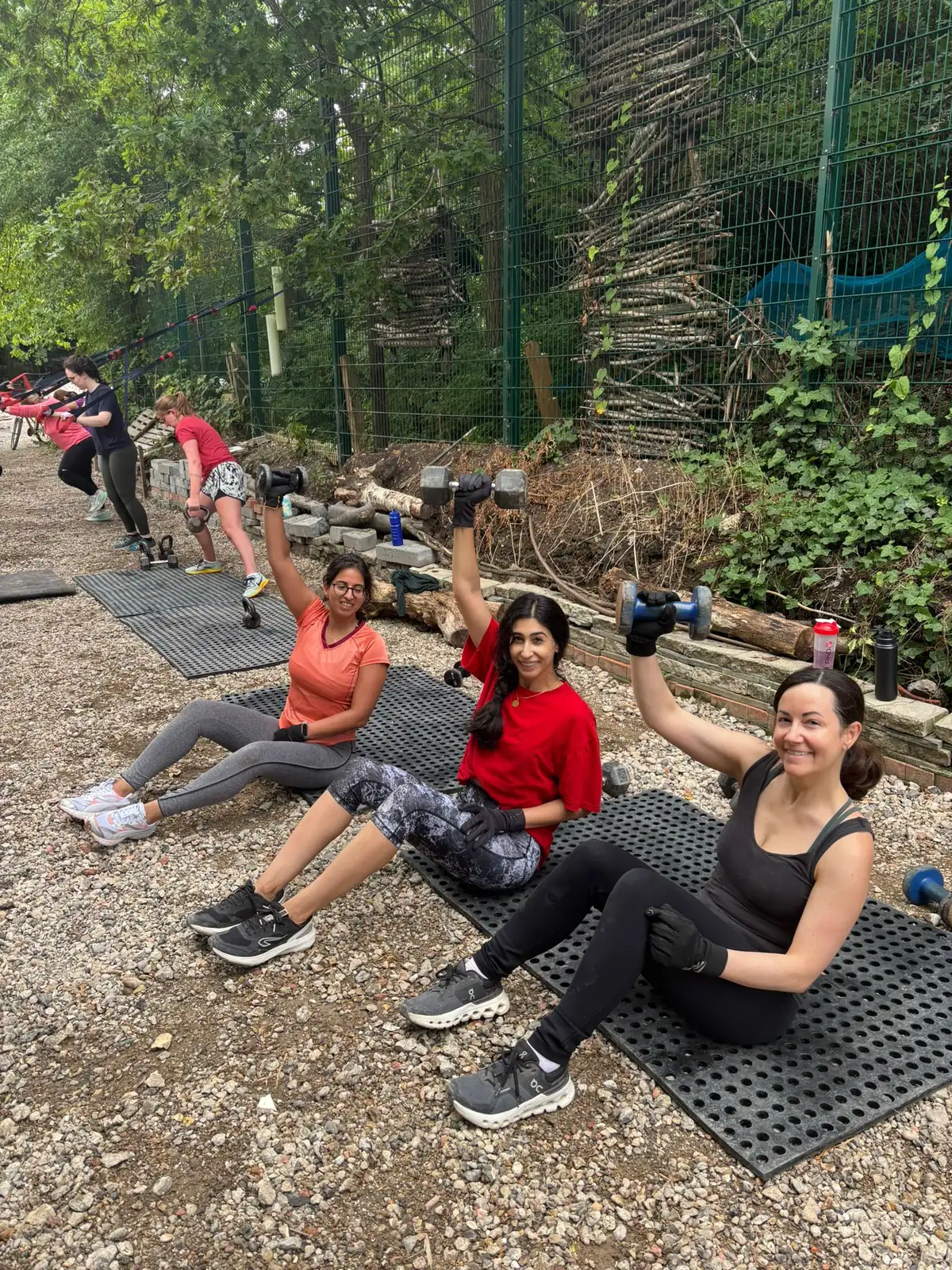 Bootcamp SE16 members working through a floor exercise on mats outdoors