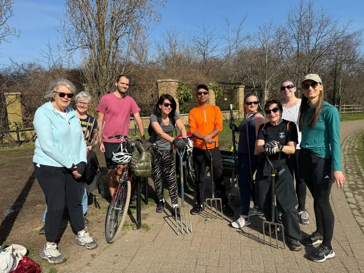Bootcamp SE16 members holding litter pickers before a community clean-up around the park