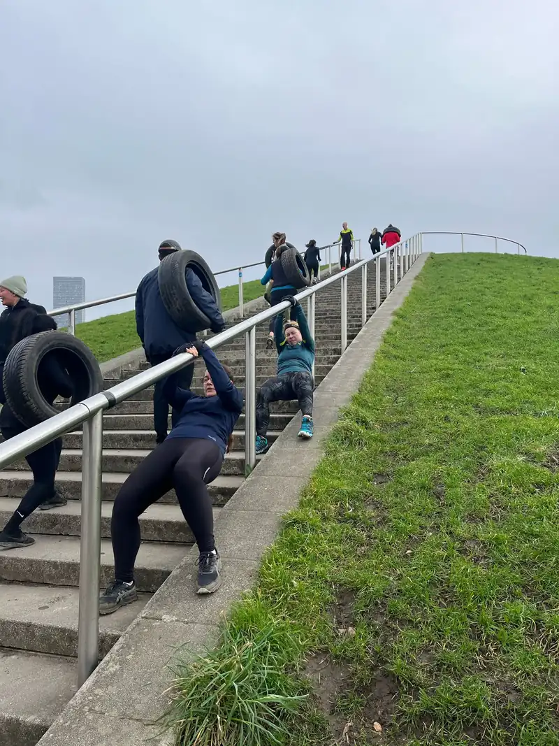 Members working through step repeats on the Stave Hill steps, mid-session