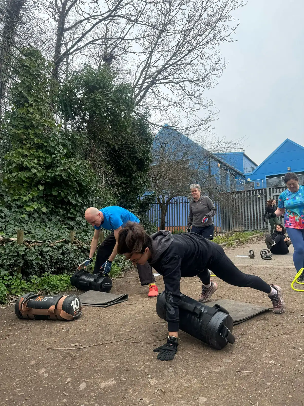 A Bootcamp SE16 session in full flow at the shed, members mid-exercise with kettlebells and bands